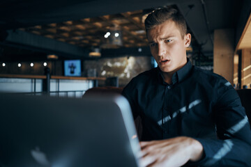 Business man freelancer with laptop in cafe at the table manager documents cup of coffee model