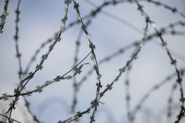 Fototapeta na wymiar barbed wire on a fence, close up