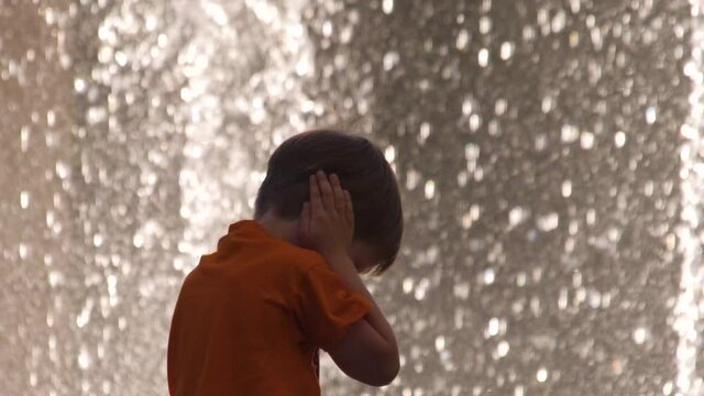 Kid covers his ears with hands to protect from noise. Denial conception. Child negative reaction, emotions on surroundings, environment. Pediatrics background. Psychology concept. Intense sensitivity