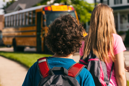 School Bus: Boy Waits With Group For School Bus