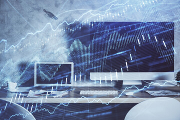 Double exposure of graph and financial info and work space with computer background. Concept of international online trading.