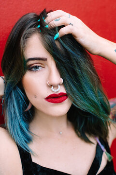 Portrait of a young rocker / alternative woman with tattoos and septum piercing