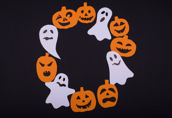 Round frame from halloween paper simbols pumpkins and spirits.