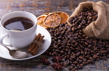 Cup with freshly brewed coffee drink and bag with beans.