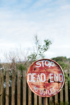 No outlet dead end stop sign on post at end of road