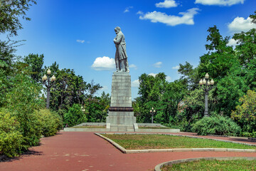 Dnipro, Ukraine - July 21, 2020: Side view of the monument to Taras Shevchenko on Monastyrsky Island in Dnipro. Sculpture of the famous Ukrainian poet Kobzar in the summer park - obrazy, fototapety, plakaty