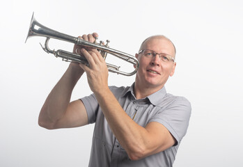 adult senior man playing the trumpet isolated on white background