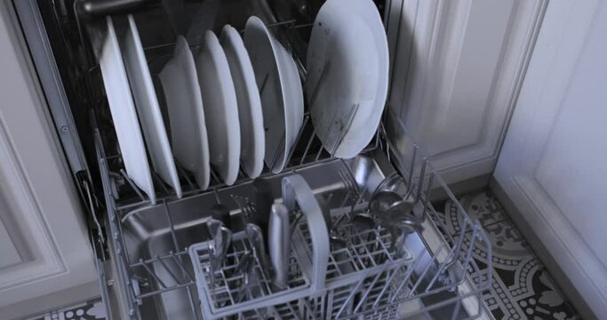 Loading the automatic dishwasher with dirty dishes