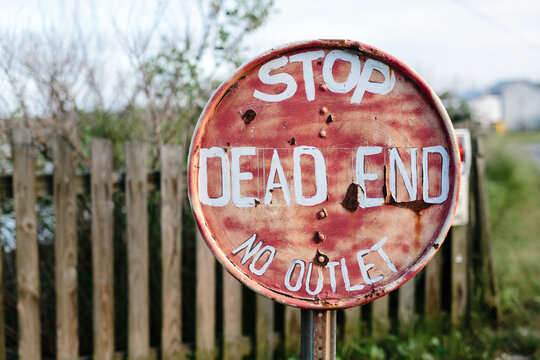 No outlet dead end stop sign on post at end of road