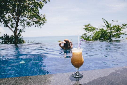 Cold coffee on the edge of swimming pool