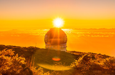 Astronomical Observatory of the Caldera de Taburiente in a beautiful orange sunset with the sun above, La Palma, Canary Islands. Spain
