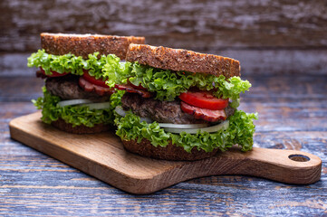 Homemade sandwich with fresh vegetables and beef cutlet.