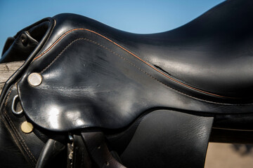 Close up view of leather black horse saddle.