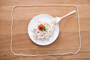 spaghetti made of yarn on table