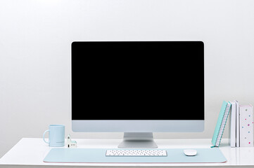 Mockup desktop computer on white table in white room.