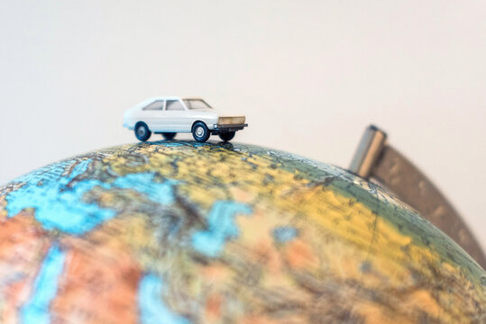 Small toy car on world globe