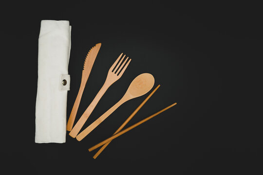 Set of eco friendly bamboo travel eating utensils alternative to single use plastics arranged in a pattern, wooden cutlery. Zero waste traveling, backpacking portable set 