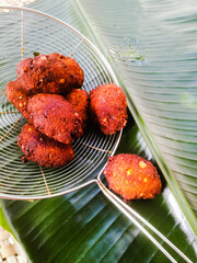 Fried parippu vada placed in a banana leaf in traditional fashion.