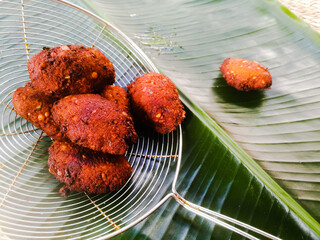 Fried parippu vada placed in a banana leaf in traditional fashion.