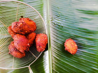 Fried parippu vada placed in a banana leaf in traditional fashion.