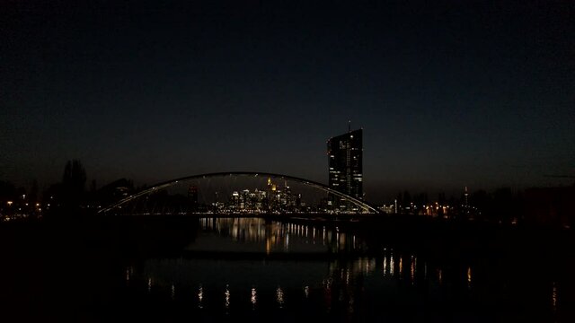 Illuminated bridge and cityscape at night, Frankfurt, Hesse, Germany