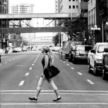 Woman in Workout clothes walking across street