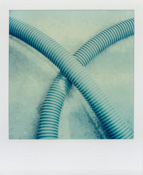 Detail of industrial plastic pipes on ground (Polaroid SX-70 print)