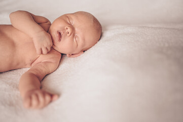 Cute emotional newborn funny little baby boy sleeping in crib. Baby goods packaging template. Healthy child, concept of hospital and happy motherhood. Infant baby. Nursery