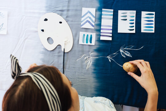 Female Artist Making Textile Print with Potato Stamps