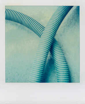 Detail of industrial plastic pipes on ground (Polaroid SX-70 print)
