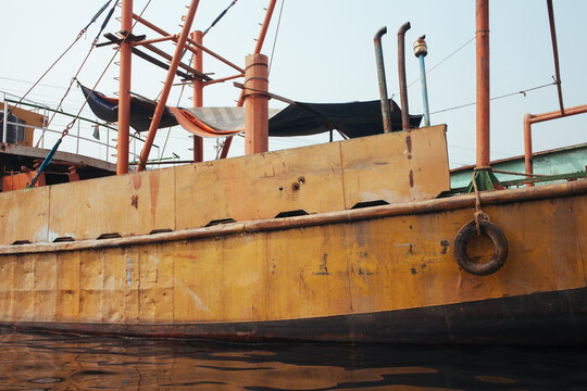 An old rusted ship on a shipyard.