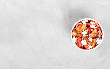 Fresh tomato salad with cottage cheese, onion, dill in a bowl on a light background copy space