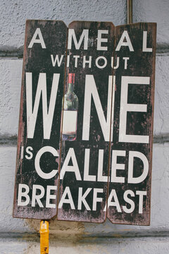 Funny sign on a wall in front of the restaurant