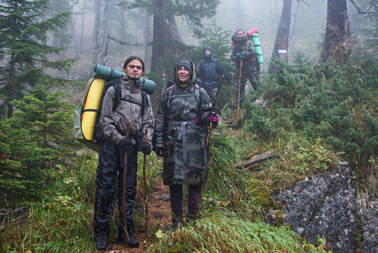 A group of tourists in rainy forest