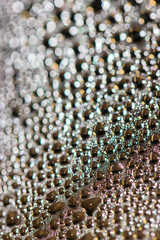 Many colorful little bubbles on the glass surface close-up