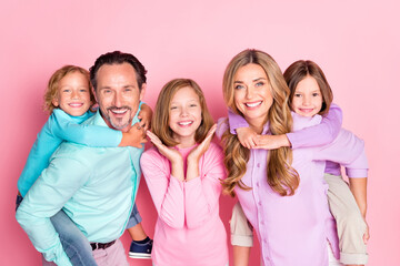 Positive harmony idyllic big family portrait photo of daddy mommy piggyback carrying small kids on...