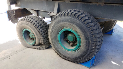 close-up shot of a flat tire of a farm trailer