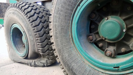 close-up shot of a flat tire of a farm trailer