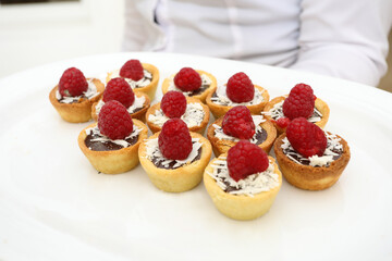 Chocolate and pastry desert with raspberries on top.