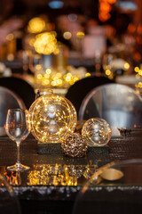 Fairy lights in a glass dome on a table for an event.