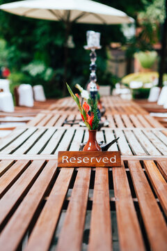 Reserved sign on a wooden table.