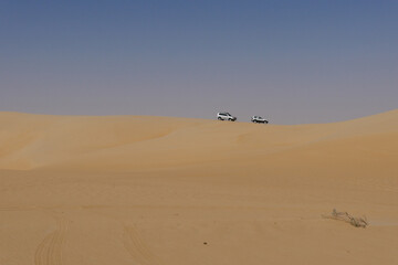 Fototapeta na wymiar 4X4 vehicles roaming the the Empty Quarter in the Saudi Arabian desert area