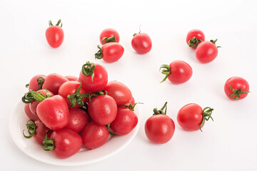 Red small tomatoes on white background