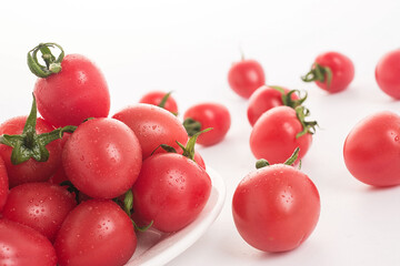 Red small tomatoes on white background