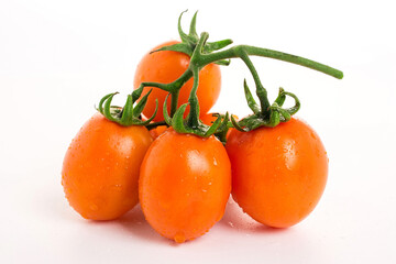 Golden yellow tomatoes on white background