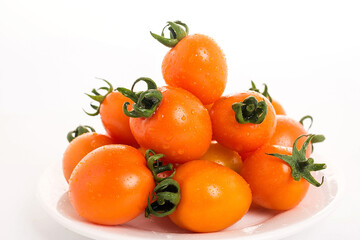 Golden yellow tomatoes on white background
