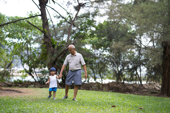 Toddler spending time with grandfather in the park