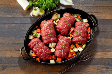 High angle view of raw beef roulades and veggies
