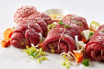 Preparing a dish of fresh beef roulades