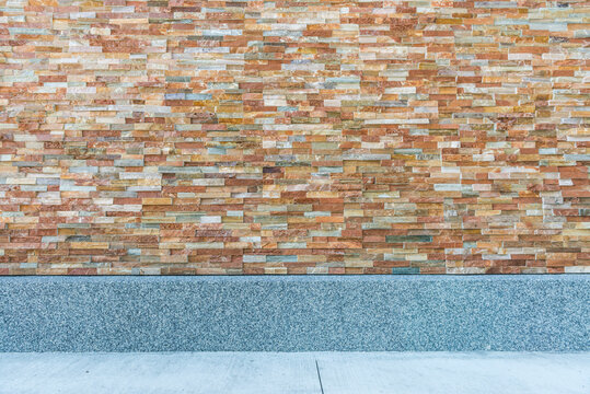 Stone wall stacked by slate and cement floor